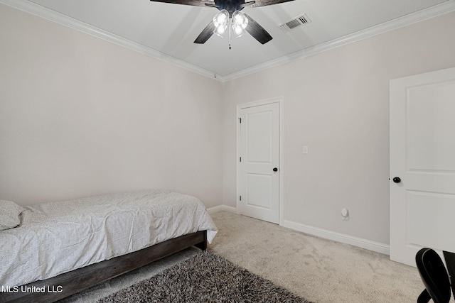 carpeted bedroom featuring ornamental molding and ceiling fan