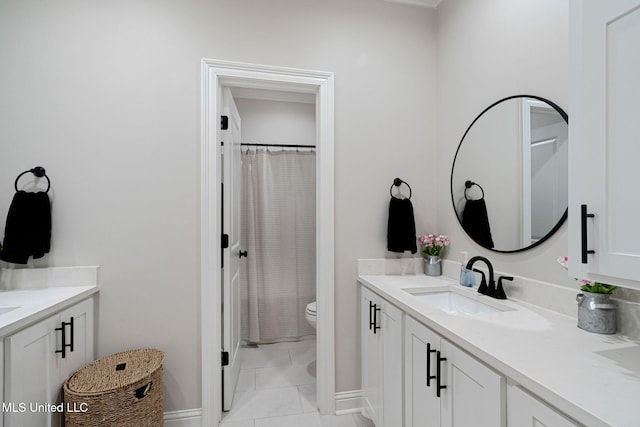 bathroom with vanity, toilet, and tile patterned flooring