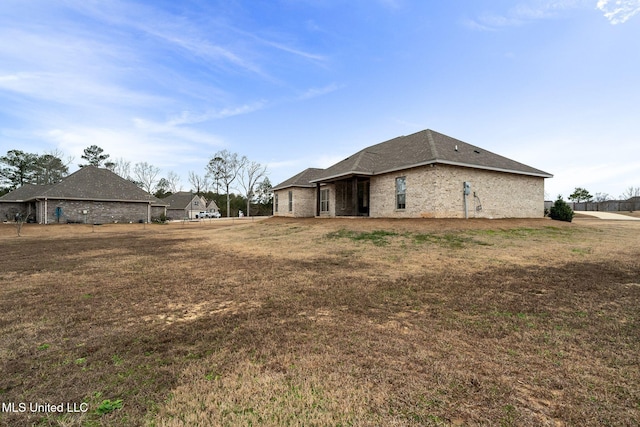 view of side of property with a yard