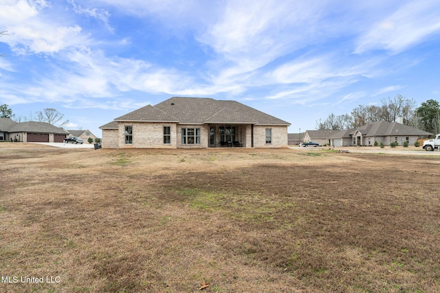 back of property featuring a lawn