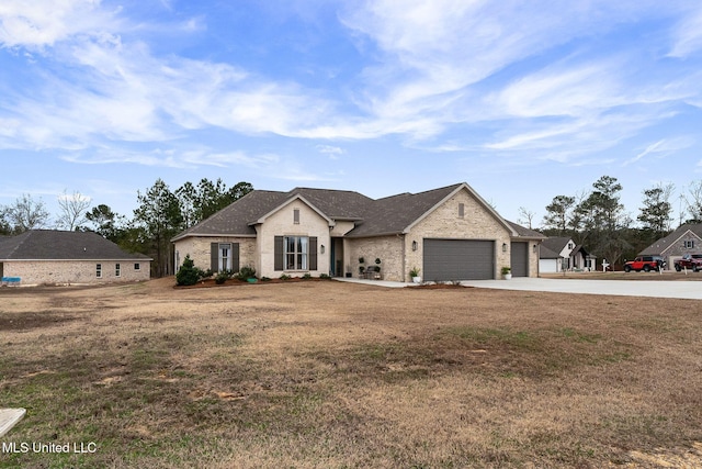 french country home with a garage and a front lawn