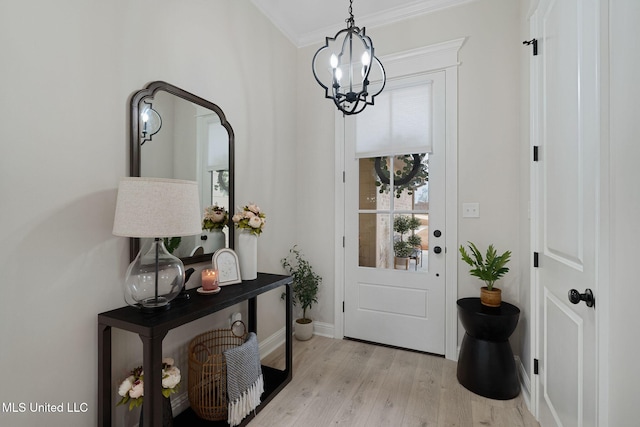 entryway with crown molding, light hardwood / wood-style floors, and a chandelier