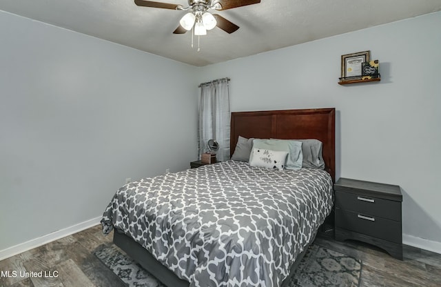 bedroom featuring dark wood-type flooring and ceiling fan