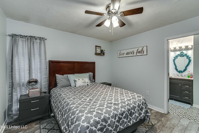 bedroom with sink, ensuite bath, ceiling fan, hardwood / wood-style floors, and a textured ceiling