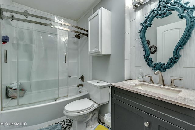 full bathroom featuring bath / shower combo with glass door, vanity, and toilet