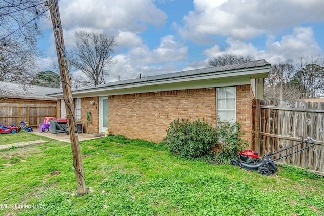 back of house featuring a yard and a patio area