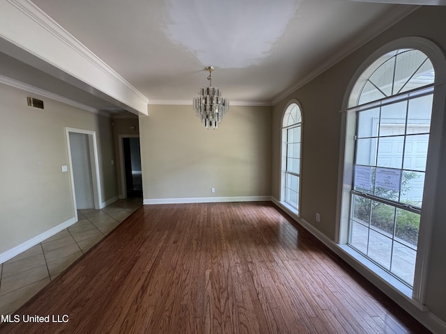 314 Fox Holw, Canton, MS 39046 - empty room with a chandelier, wood finished floors, crown molding, and baseboards