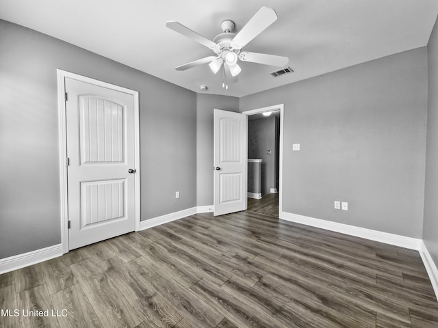 unfurnished bedroom featuring baseboards, a ceiling fan, dark wood-style floors, and visible vents
