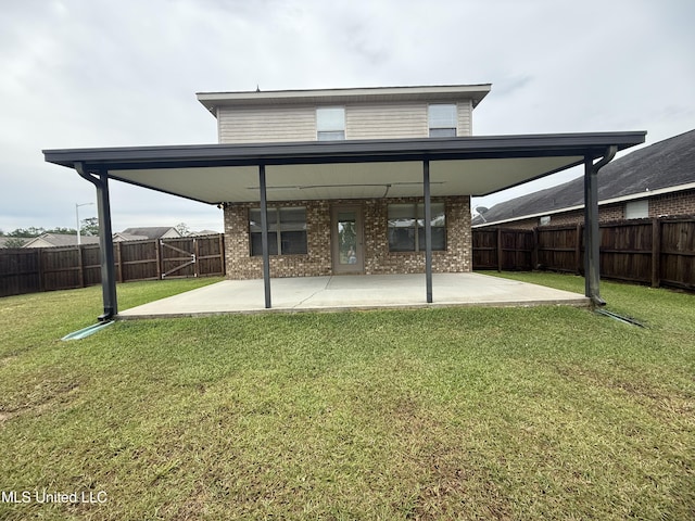 rear view of house featuring a fenced backyard, a patio, a lawn, and brick siding