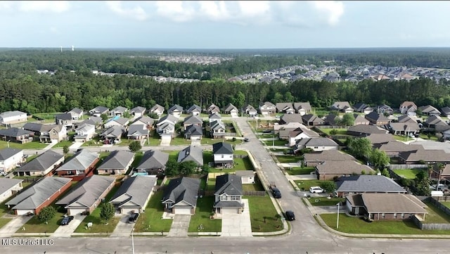 drone / aerial view featuring a view of trees and a residential view