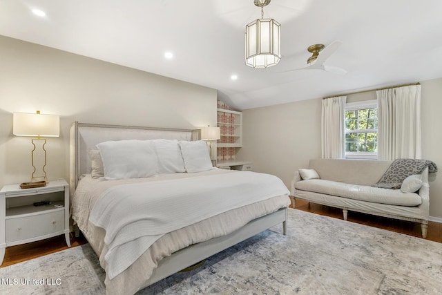 bedroom with recessed lighting, vaulted ceiling, baseboards, and wood finished floors