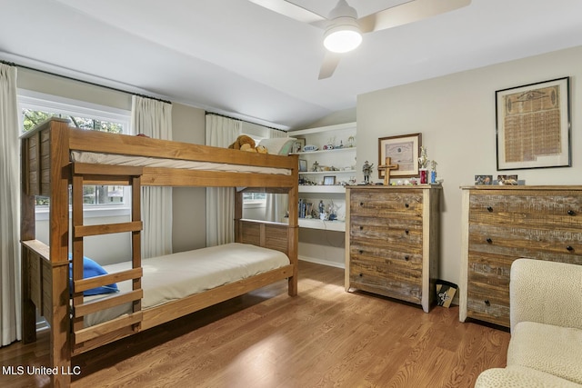 bedroom featuring lofted ceiling and wood finished floors