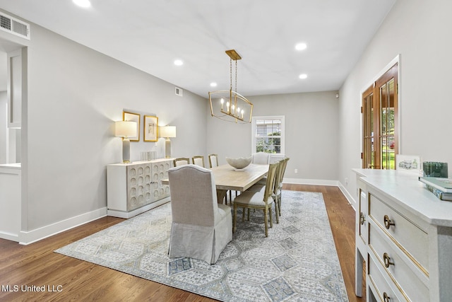 dining area featuring dark wood-type flooring, visible vents, and baseboards