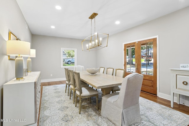 dining room with light wood-style floors, baseboards, and recessed lighting