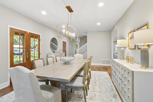 dining space featuring recessed lighting, visible vents, stairway, wood finished floors, and baseboards