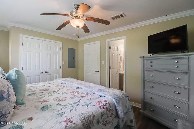bedroom with a closet, electric panel, dark wood finished floors, ornamental molding, and visible vents