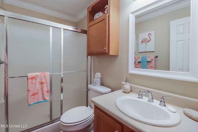 bathroom featuring a shower stall, toilet, vanity, and ornamental molding