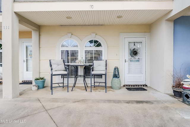 property entrance with stucco siding