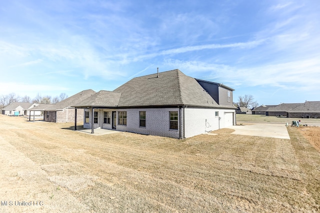 rear view of house with a yard and a patio area