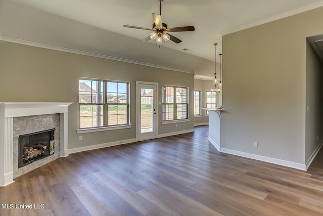 unfurnished living room with ceiling fan, wood-type flooring, and ornamental molding