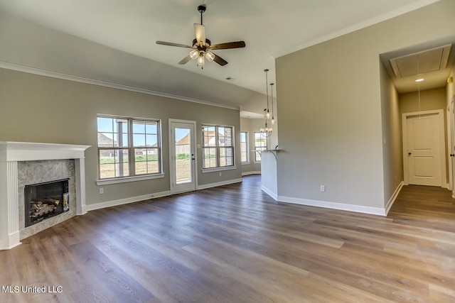 unfurnished living room with ornamental molding, a fireplace, hardwood / wood-style flooring, and ceiling fan