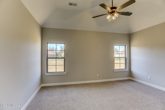 spare room featuring ceiling fan, carpet flooring, and vaulted ceiling