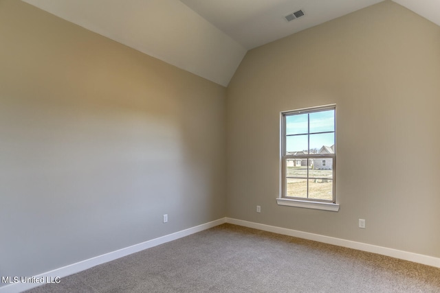 spare room with lofted ceiling and carpet