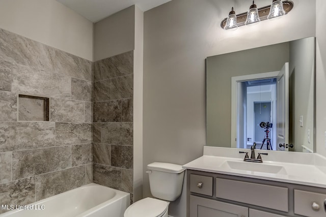 full bathroom with vanity, toilet, and tiled shower / bath