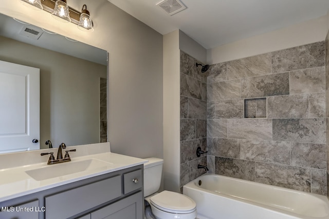 full bathroom with vanity, toilet, and tiled shower / bath combo