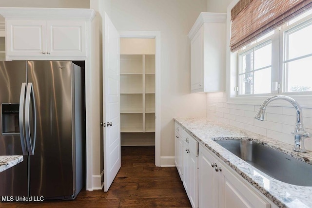 132 Freeland Ln, Clinton, MS 39056 - kitchen with stainless steel fridge with ice dispenser, backsplash, white cabinets, and dark wood-style flooring