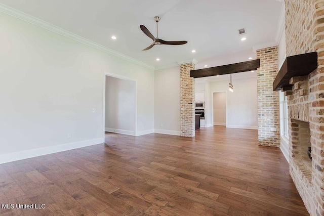 132 Freeland Ln, Clinton, MS 39056 - unfurnished living room featuring a brick fireplace, ceiling fan, dark wood finished floors, ornamental molding, and recessed lighting