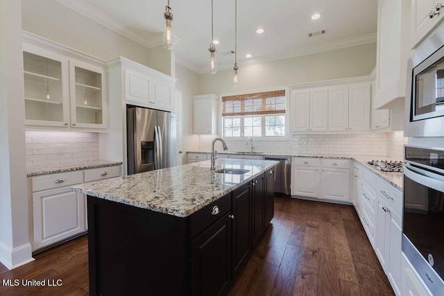 132 Freeland Ln, Clinton, MS 39056 - kitchen featuring stainless steel appliances, white cabinets, crown molding, tasteful backsplash, and glass insert cabinets