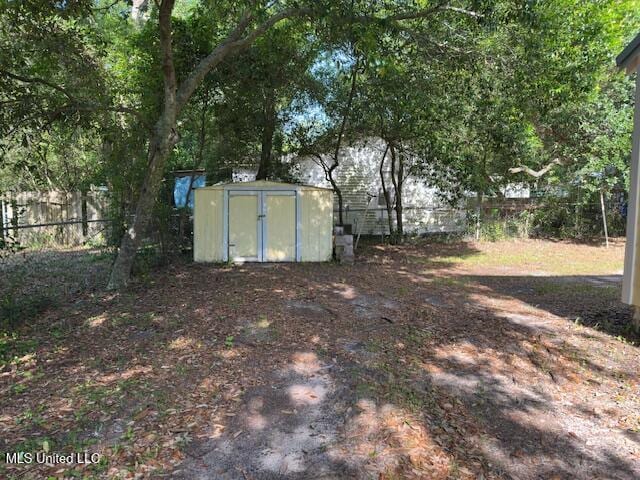 153 Saint Peter St, Biloxi, MS 39530 - view of yard with a storage unit, fence, and an outbuilding