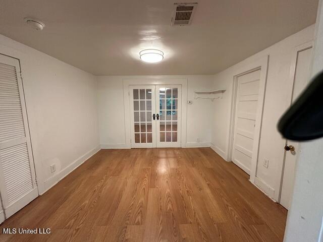153 Saint Peter St, Biloxi, MS 39530 - unfurnished dining area featuring french doors, wood finished floors, and baseboards