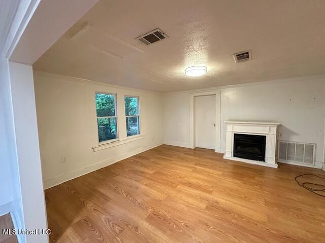 153 Saint Peter St, Biloxi, MS 39530 - unfurnished living room with light wood finished floors, a glass covered fireplace, and baseboards