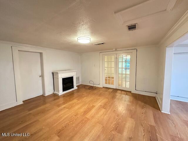 153 Saint Peter St, Biloxi, MS 39530 - unfurnished living room with a fireplace, wood finished floors, a textured ceiling, and baseboards