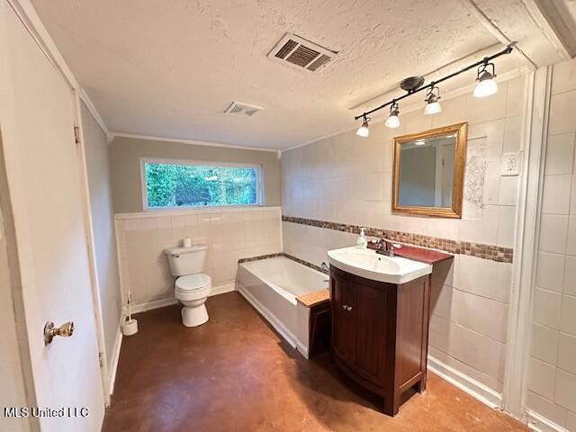 153 Saint Peter St, Biloxi, MS 39530 - bathroom with tile walls, concrete flooring, a bath, toilet, and vanity