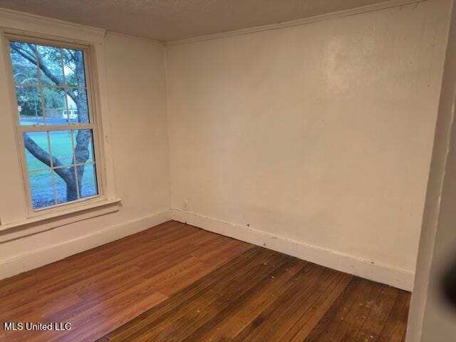 153 Saint Peter St, Biloxi, MS 39530 - empty room featuring dark wood-style flooring, baseboards, and crown molding