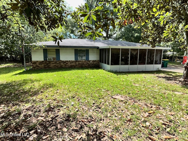 view of front of property with a front yard and a sunroom