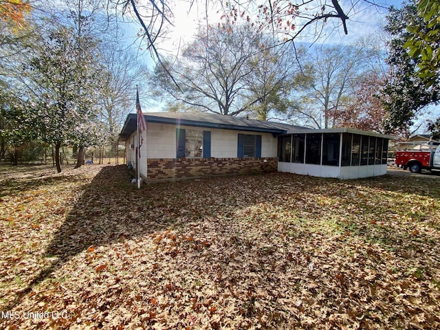 rear view of house with a sunroom