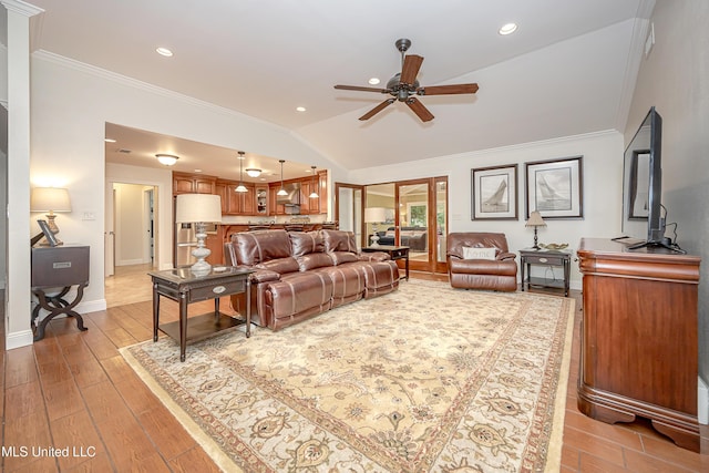 living room with ceiling fan, ornamental molding, light wood-type flooring, vaulted ceiling, and baseboards