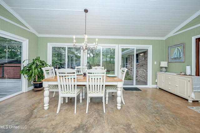 dining area with healthy amount of natural light, a chandelier, ornamental molding, vaulted ceiling, and baseboards