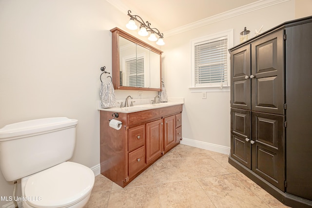 bathroom with baseboards, toilet, crown molding, and vanity