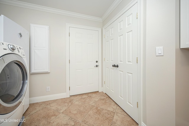 clothes washing area with washer / clothes dryer, baseboards, ornamental molding, and cabinet space
