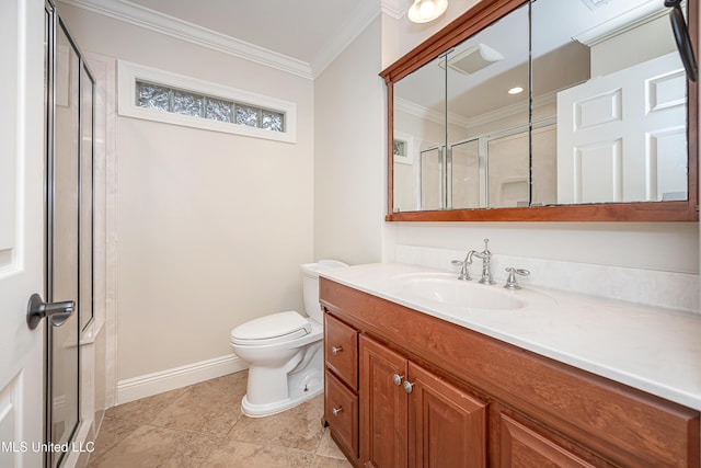bathroom featuring ornamental molding, a stall shower, toilet, vanity, and baseboards