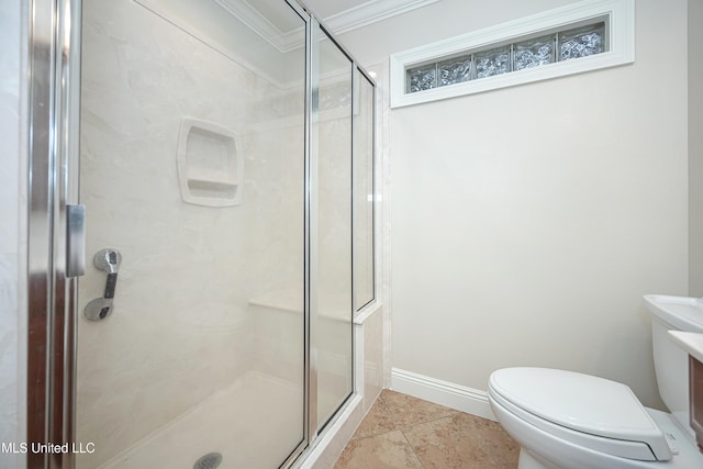 bathroom featuring ornamental molding, a shower stall, toilet, and baseboards