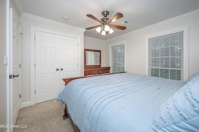 bedroom with crown molding, light carpet, a closet, ceiling fan, and baseboards
