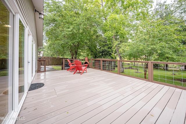 wooden terrace with a lawn