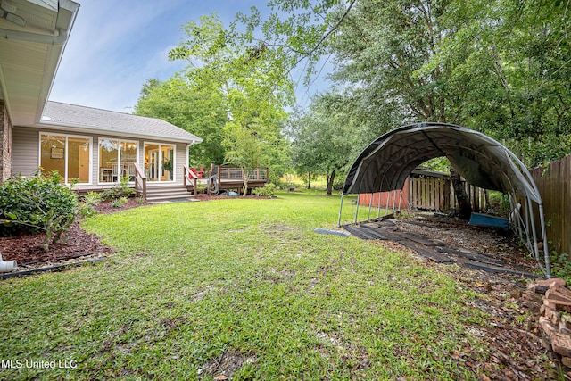 view of grassy yard featuring a deck