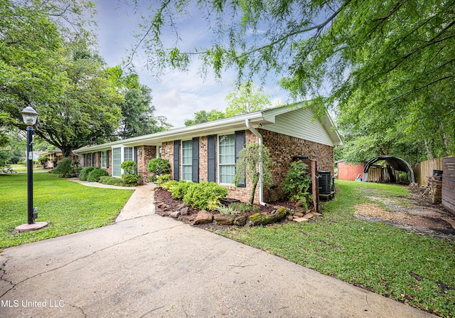 single story home featuring brick siding and central AC